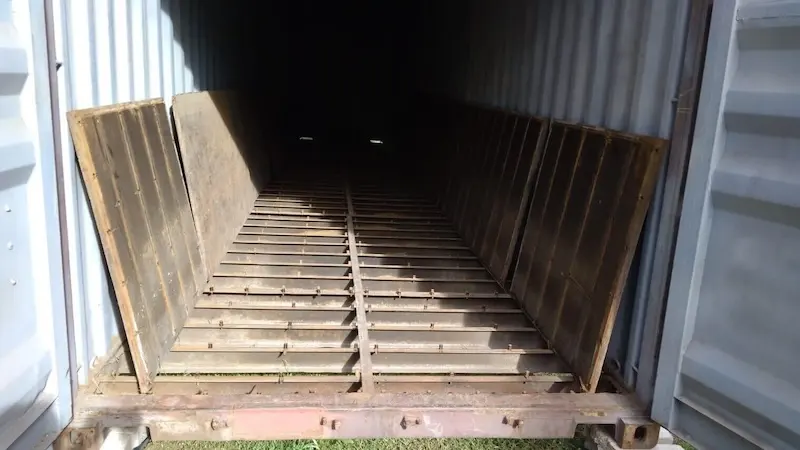 View inside a container with the wood floor removed, showing the internal steel cross members and support beams.