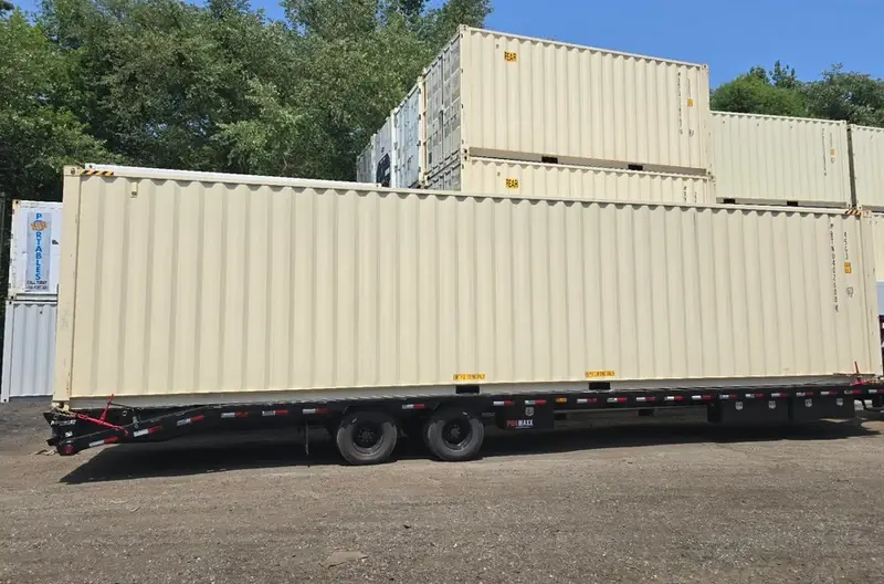 The tilt-bed truck is preparing to unload a 40ft high cube open-side container